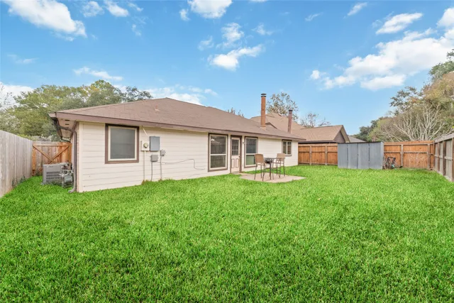 a view of a house with backyard porch and furniture