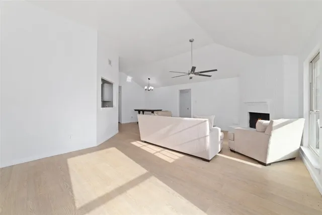 a living room with furniture and a ceiling fan