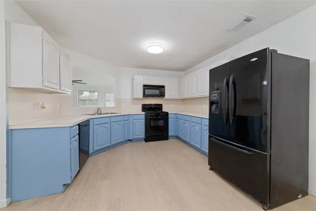 a kitchen with a refrigerator and a sink
