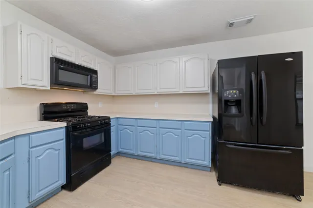 a kitchen with a refrigerator stove and microwave