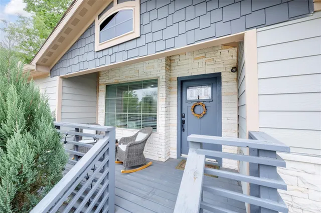 a view of a chair and tables in the balcony