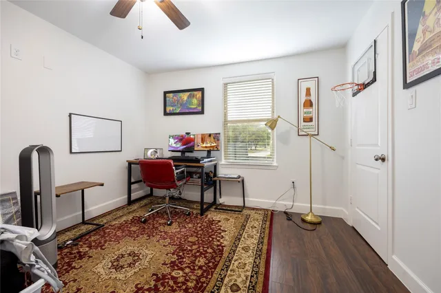a view of a workspace with furniture and a window