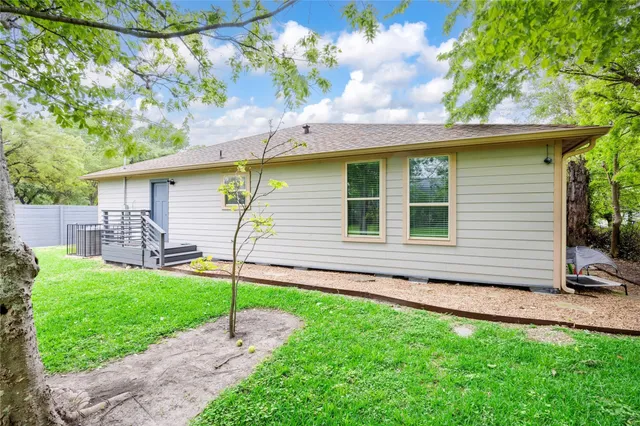 a backyard of a house with table and chairs