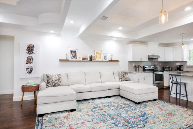 a living room with furniture and kitchen view