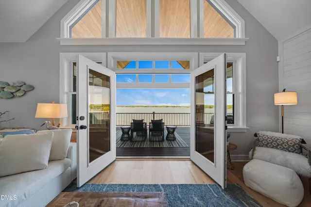 a view of a patio with table and chairs and wooden floor