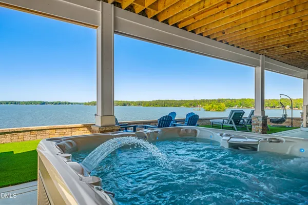 a view of a lake with lawn chairs