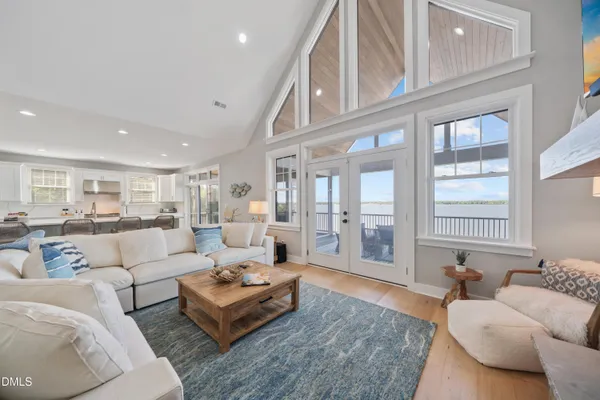 a kitchen with a dining table chairs cabinets and stainless steel appliances