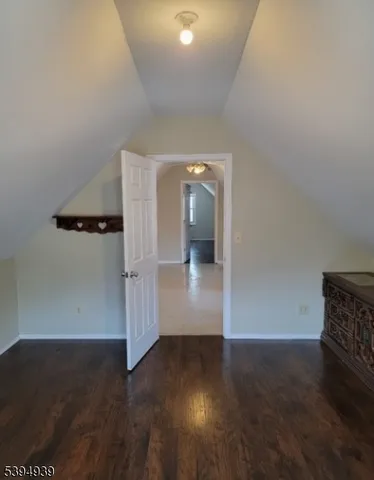 an empty room with wooden floor and cabinet