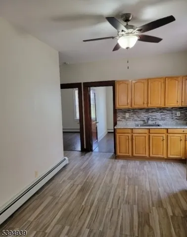 a spacious bathroom with a granite countertop sink and a mirror