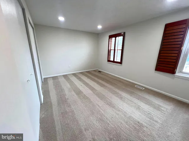 a house view with pool seating space and garden