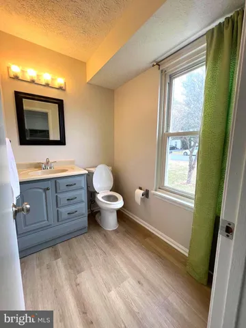 a spacious bathroom with a toilet sink and mirror