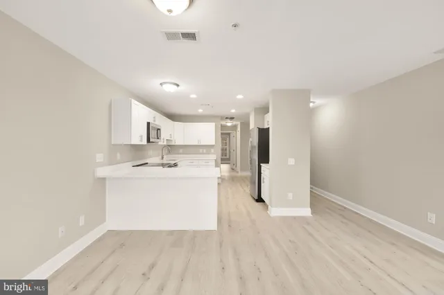 a view of kitchen with wooden floor