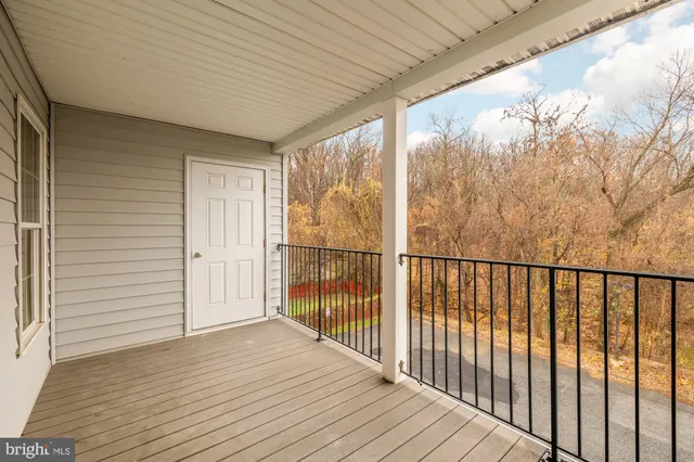 a view of a balcony with wooden floor
