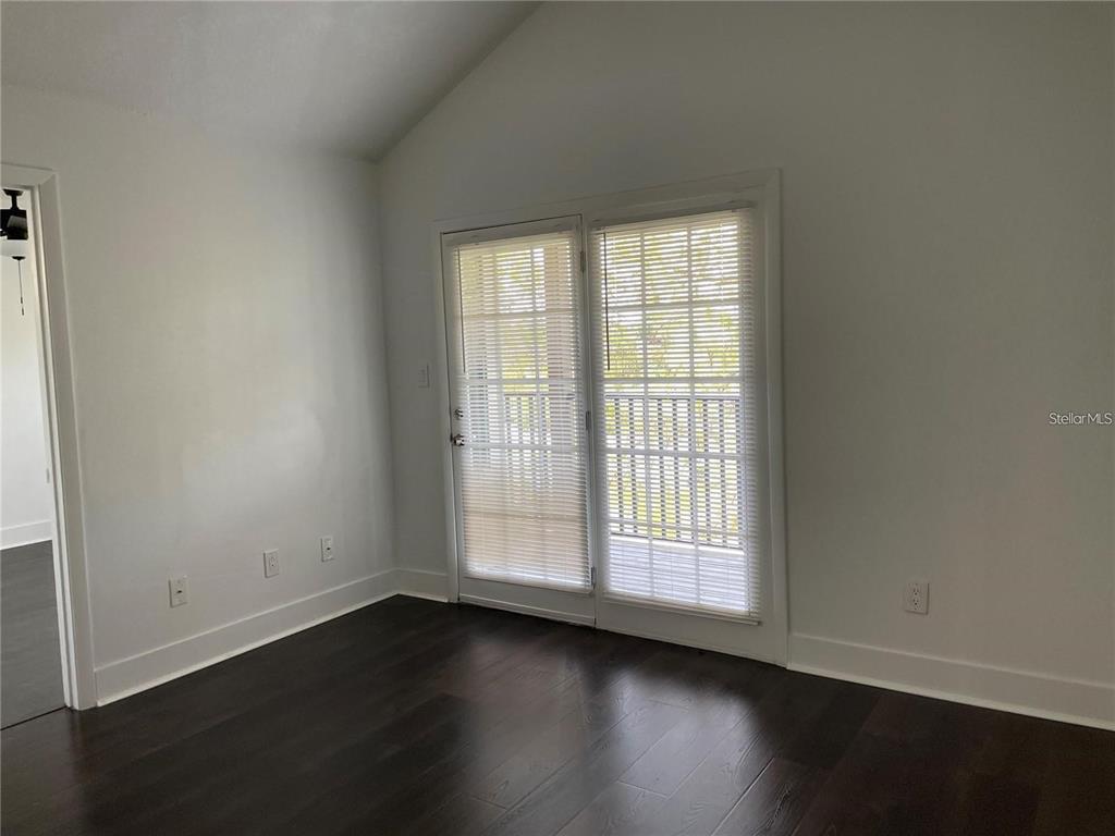 199 Afton Square, Unit 309 Altamonte Springs, FL 32714 - Photo 5 of 17 an empty room with wooden floor and windows