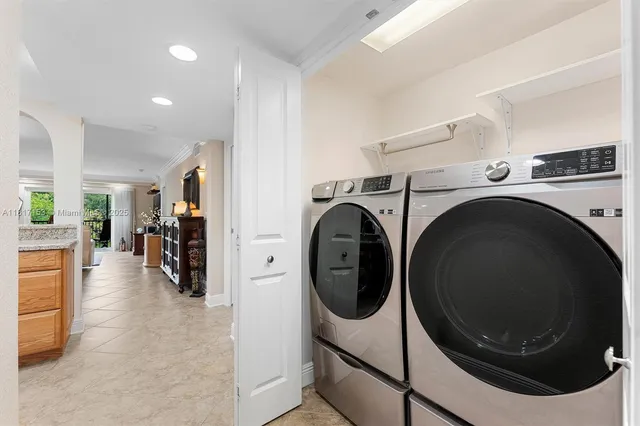 a view of a storage and utility room with washer and dryer