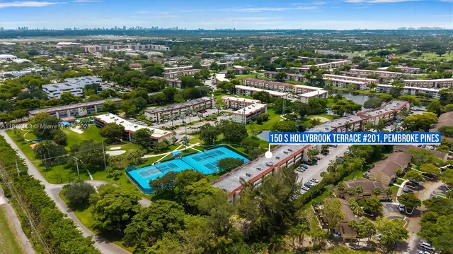 an aerial view of residential houses with outdoor space and swimming pool
