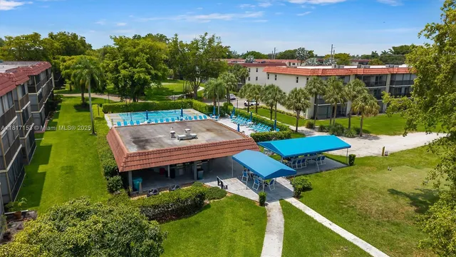 an aerial view of a house with pool a yard and lake view
