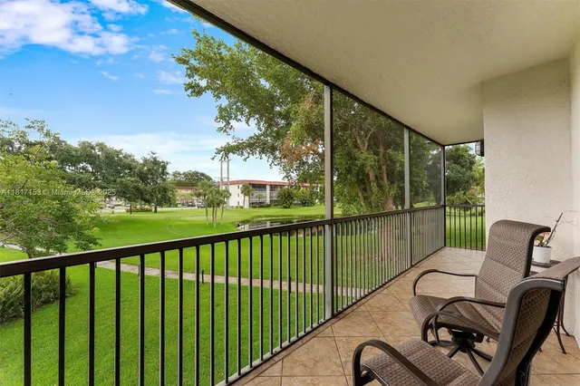 a view of roof deck with furniture and garden