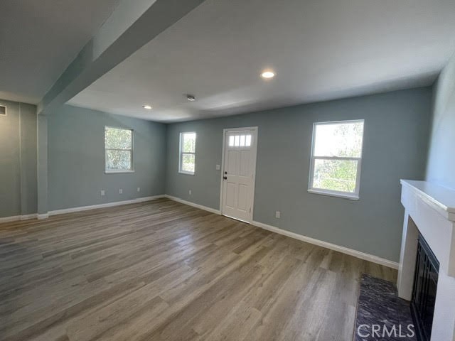 a view of empty room with window and fireplace