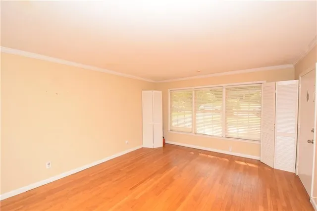 a view of a room with wooden floor and a window