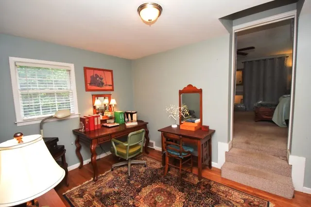 a bathroom with a granite countertop sink a toilet and shower