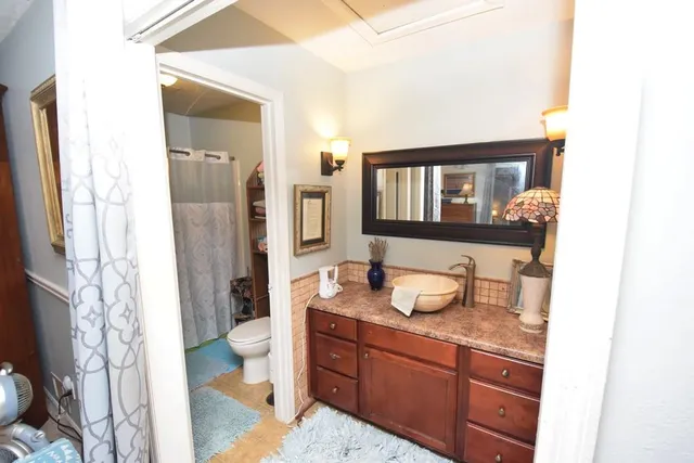 a living room with a couch and a potted plant