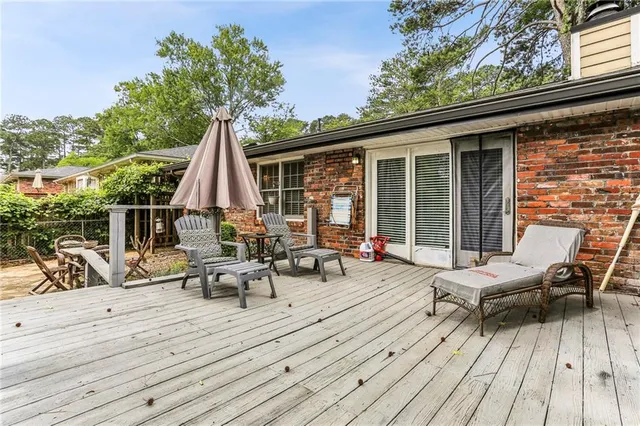 a view of a house with a yard and sitting area