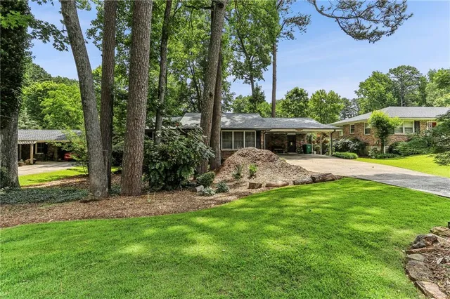 a view of a house with backyard sitting area and garden