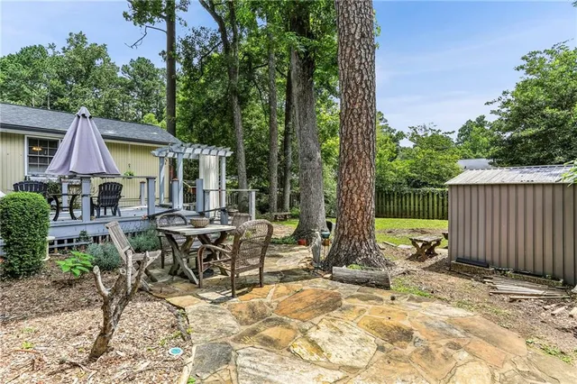 a view of a house with backyard sitting area and garden
