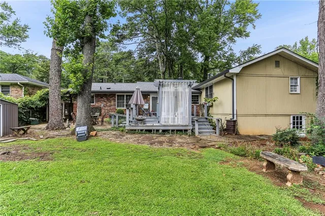 a view of a deck with table and chairs with wooden floor and fence
