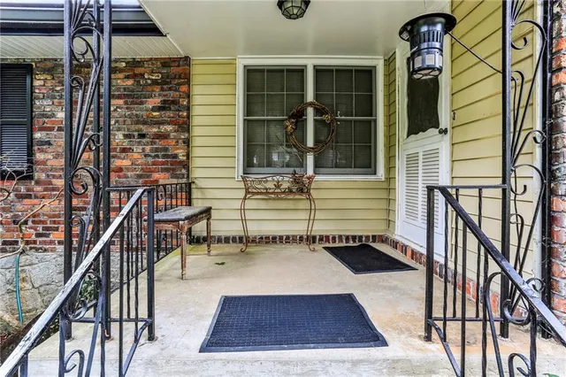 a view of balcony with two chairs and a rug