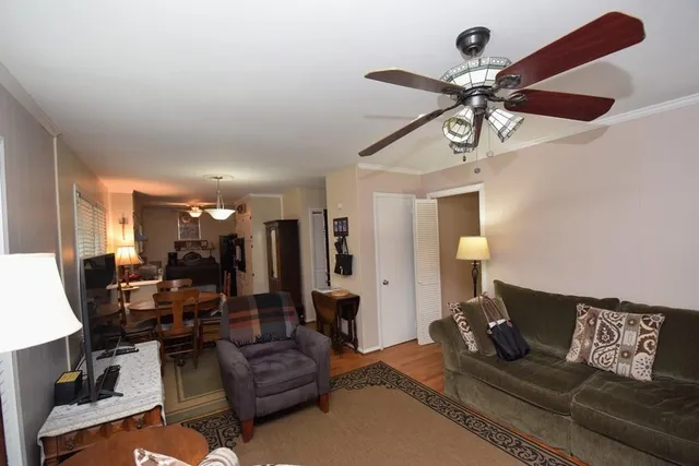 a living room with furniture and wooden floor