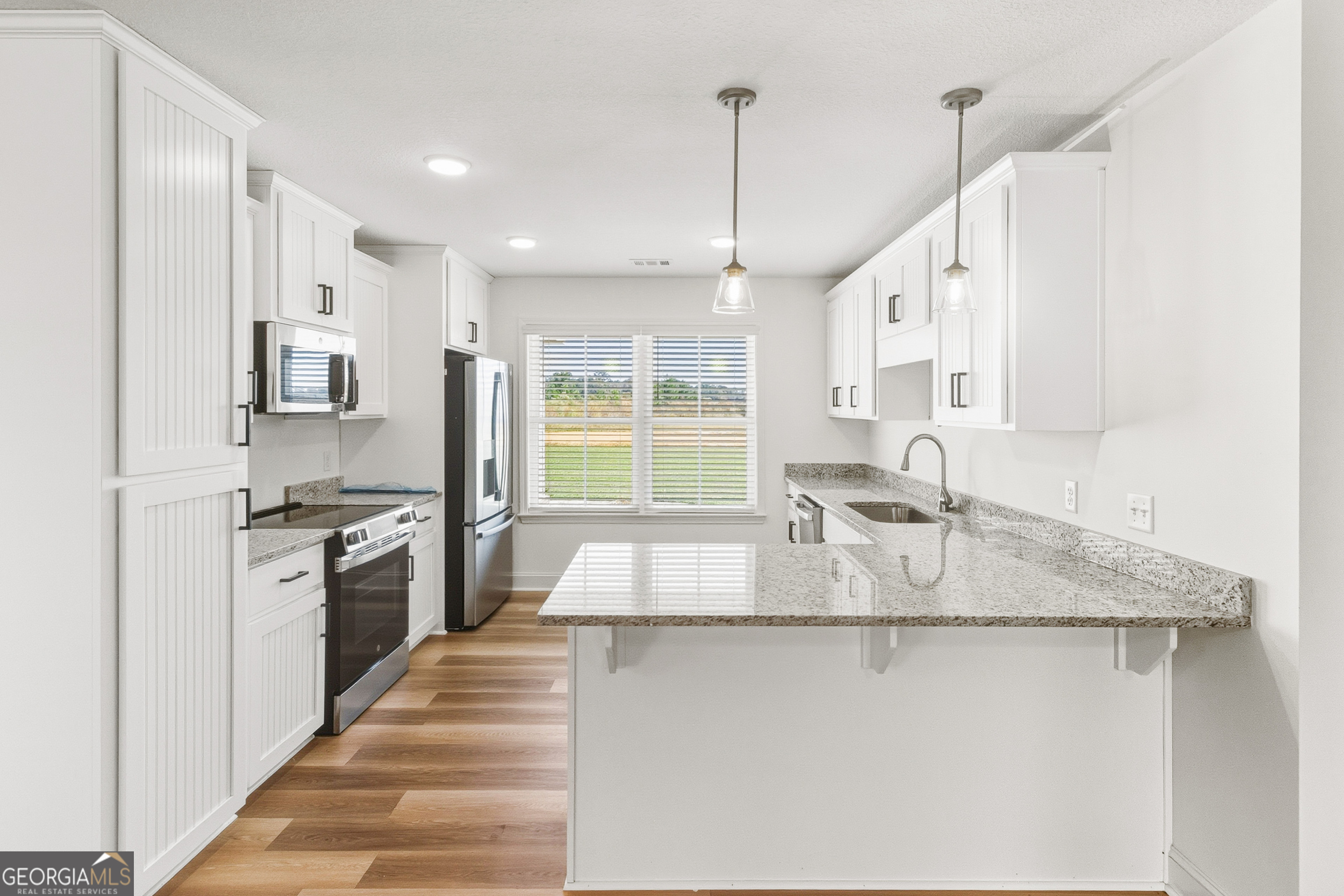 477 Jack Kennedy Road Statesboro, GA 30458 - Photo 11 of 32 a kitchen with stainless steel appliances granite countertop a sink a stove and a refrigerator