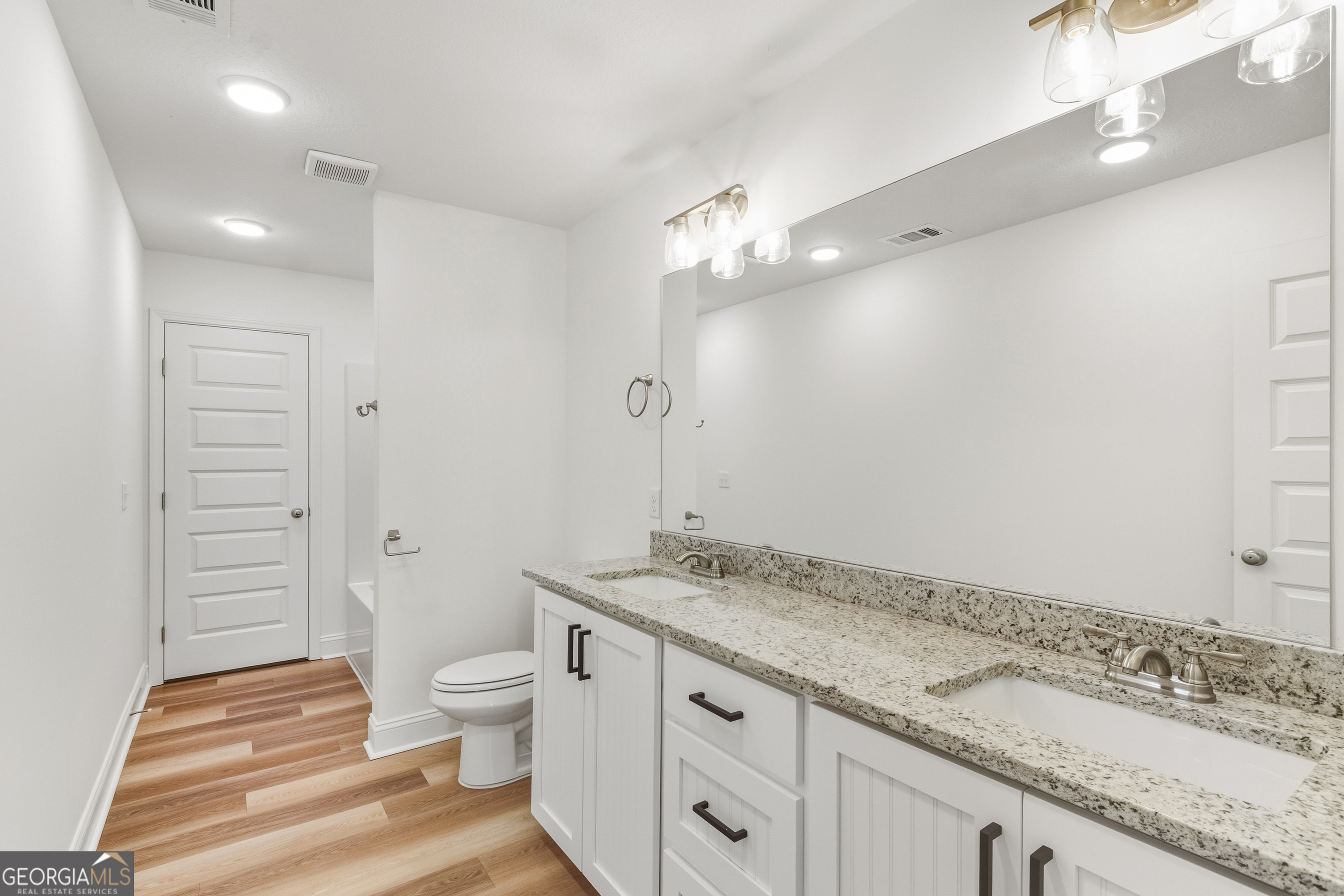 477 Jack Kennedy Road Statesboro, GA 30458 - Photo 22 of 32 a spacious bathroom with a granite countertop sink a toilet and shower