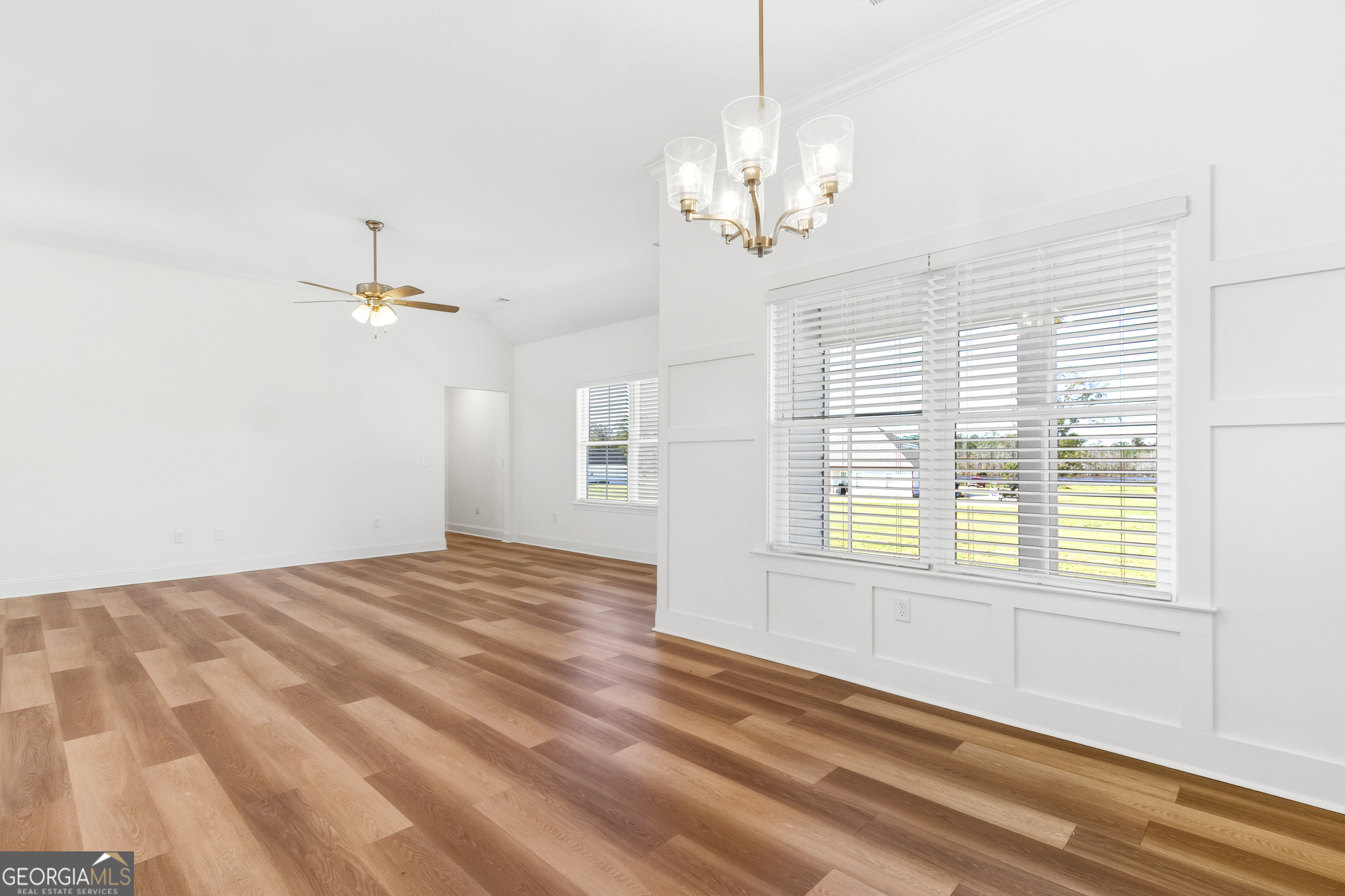477 Jack Kennedy Road Statesboro, GA 30458 - Photo 8 of 32 a view of a livingroom with a chandelier fan and windows
