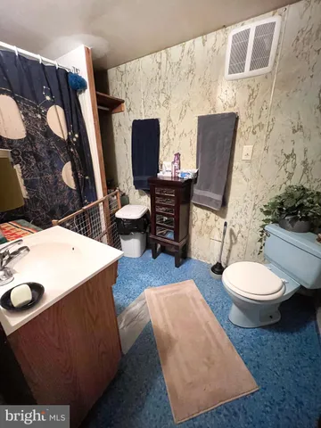 a room with furniture a flat screen tv and a lamp