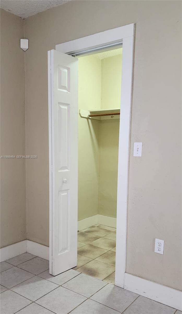 880 East 26th Street Hialeah, FL 33013 - Photo 18 of 34 an empty room that has a glass door and painted walls