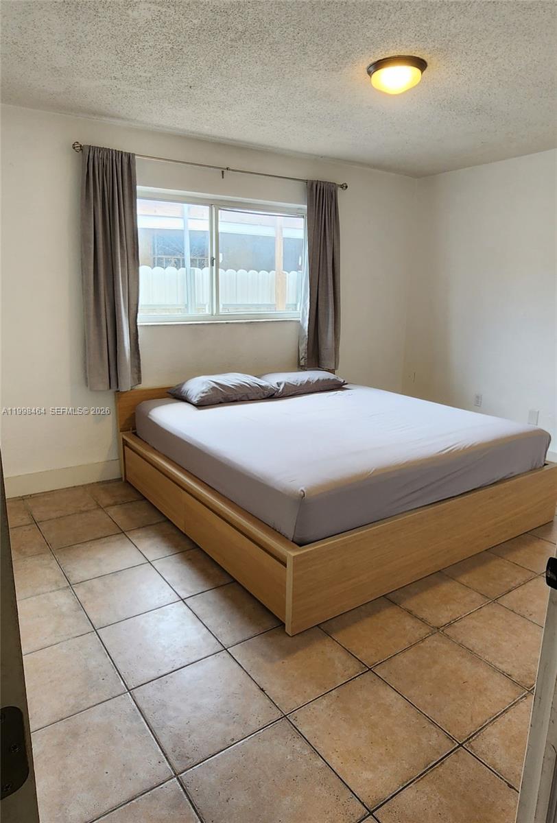 880 East 26th Street Hialeah, FL 33013 - Photo 20 of 34 a bedroom with a bed and window