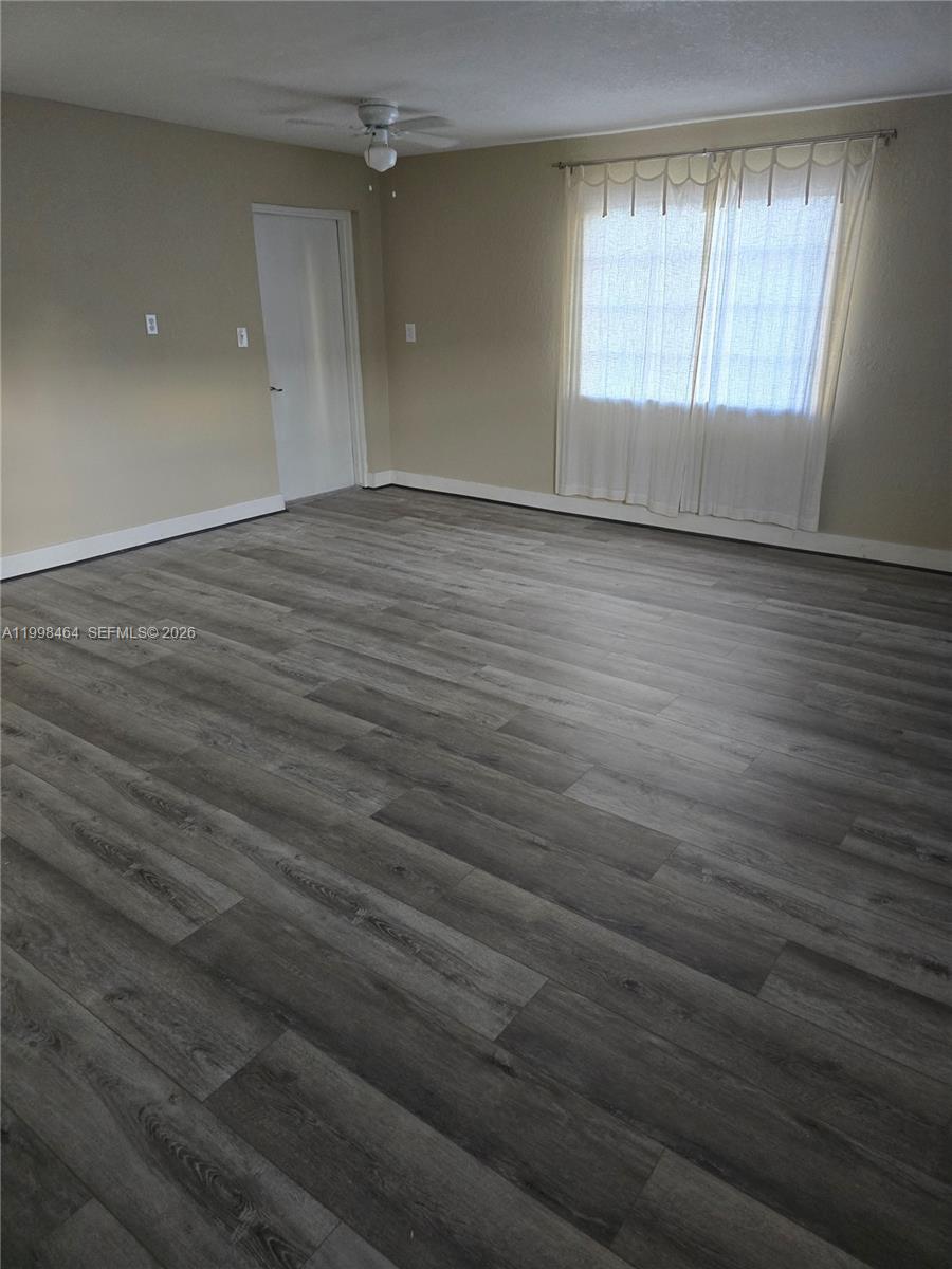 880 East 26th Street Hialeah, FL 33013 - Photo 33 of 34 an empty room with wooden floor and windows