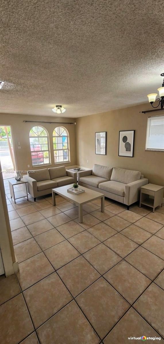 880 East 26th Street Hialeah, FL 33013 - Photo 4 of 34 a living room with furniture and a chandelier
