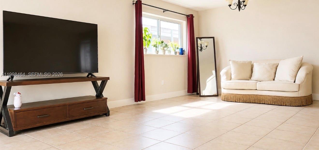 880 East 26th Street Hialeah, FL 33013 - Photo 7 of 34 a living room with furniture and a flat screen tv