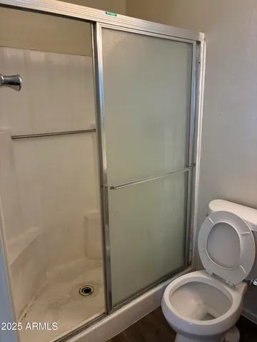 a bathroom with a toilet and a shower