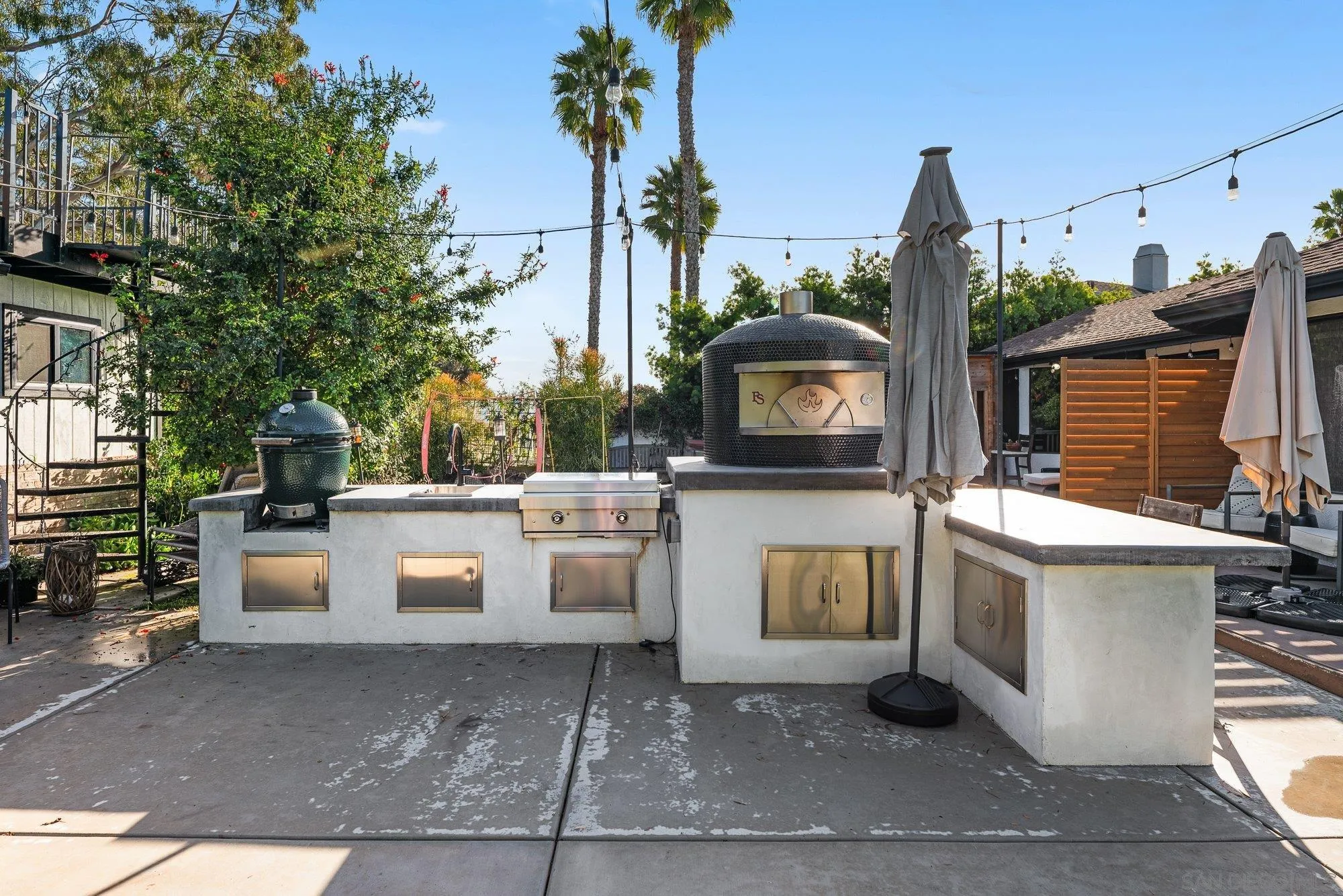 3491 Shawnee Road San Diego, CA 92117 - Photo 45 of 66 a view of a patio with table and chairs potted plants