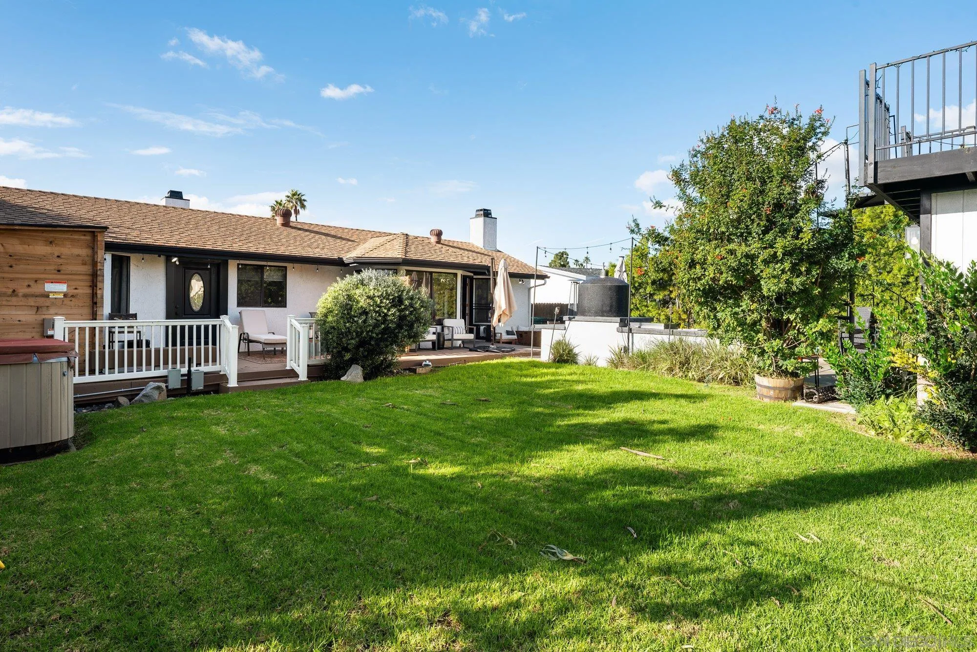 3491 Shawnee Road San Diego, CA 92117 - Photo 55 of 66 a front view of a house with a garden and porch