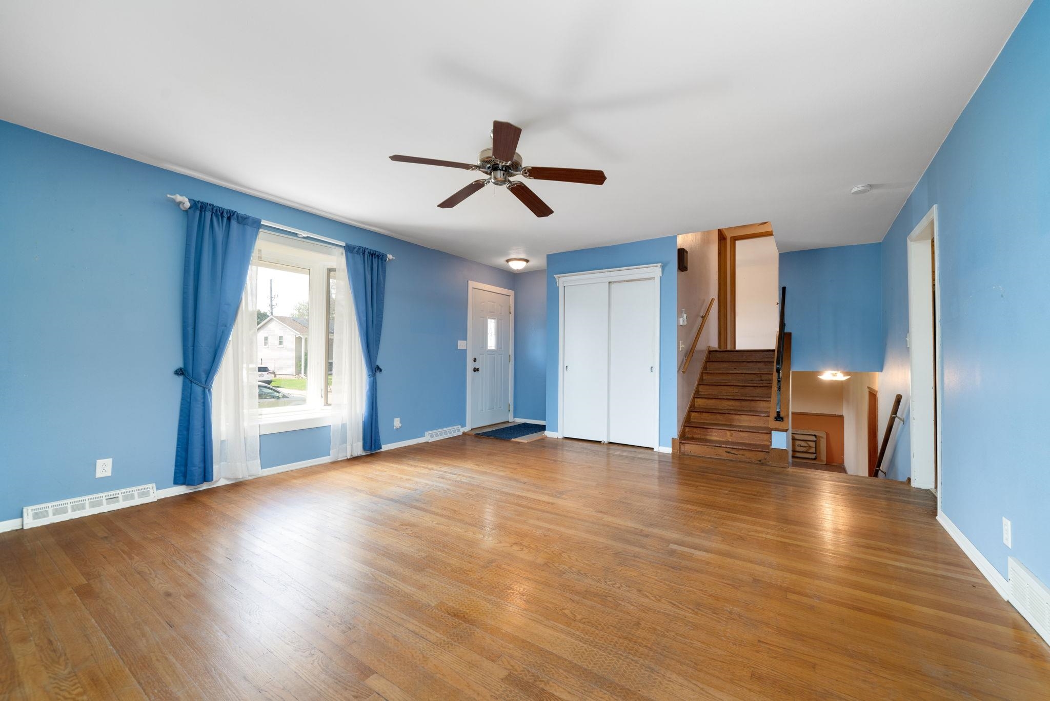 1611 Notre Dame Road Rockford, IL 61103 - Photo 3 of 33 a view of an empty room with wooden floor and a window