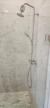 a bathroom with a bathtub and a shower