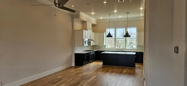 a bathroom with a sink toilet vanity and tub
