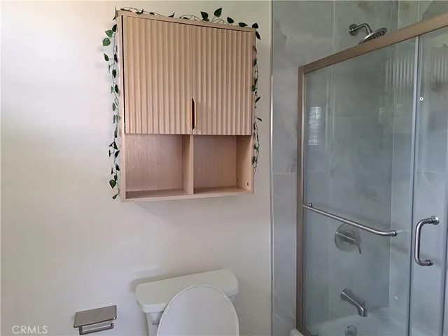 a bathroom with a granite countertop shower and a sink