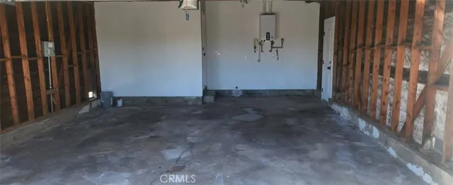 a view of a kitchen with a refrigerator and a sink