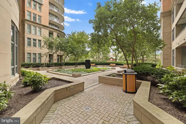 a dining room with wooden floor and large windows